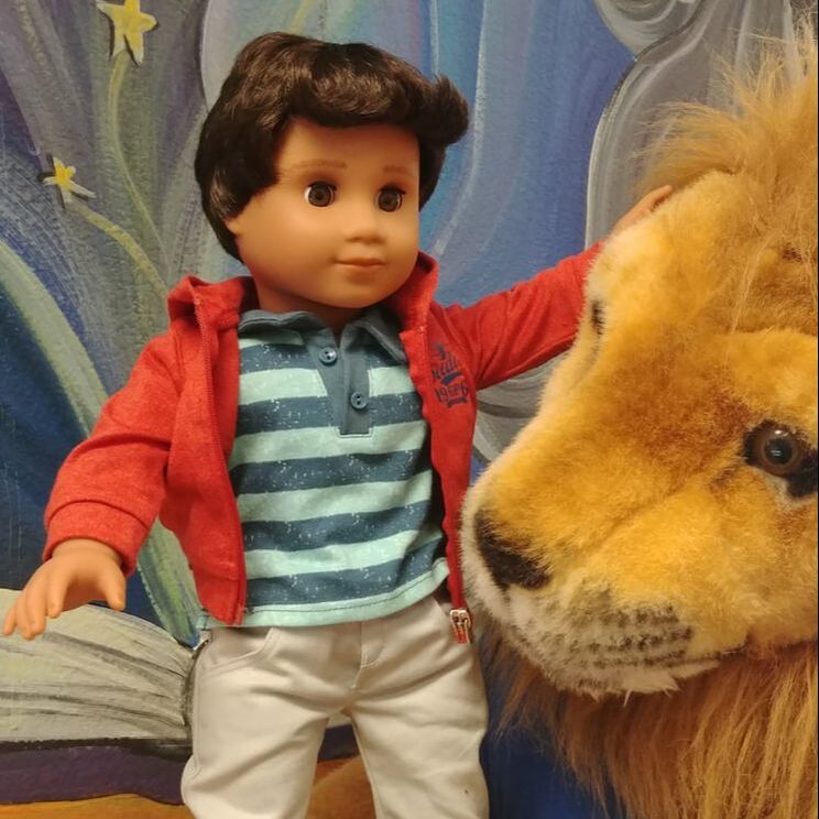 American Girl doll Booker with Lester the Lion near the library mural